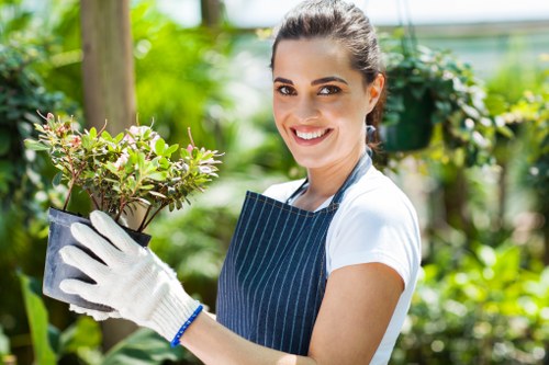 Gardener carrying out a safe garden maintenance task with protective equipment