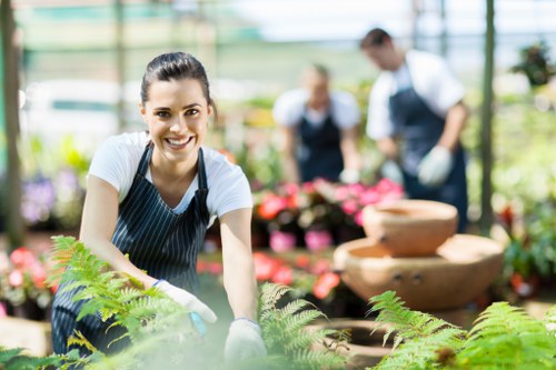 Outdoor gardening team following health and safety procedures in a maintained garden